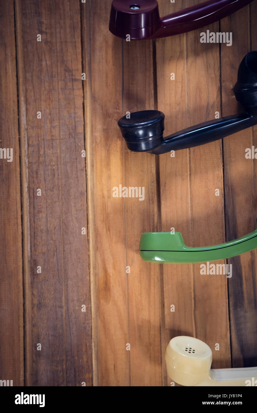 Immagine ritagliata di ricevitori telefonici sul tavolo di legno Foto Stock