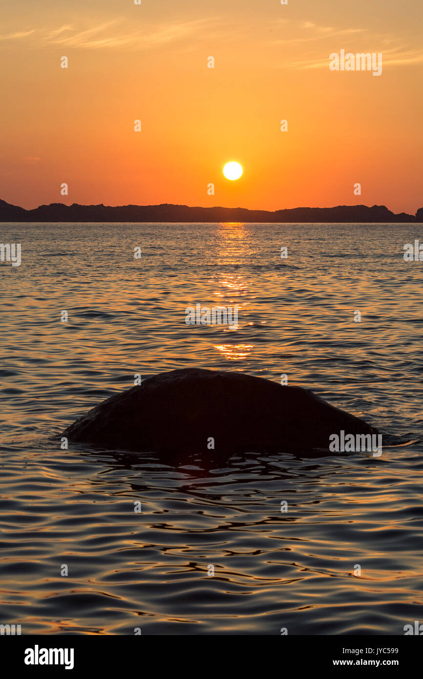 Il nuovo Sun risorto sul blu del mare tingono il cielo di colore arancione a Punta Molentis Villasimius Cagliari Sardegna Italia Europa Foto Stock