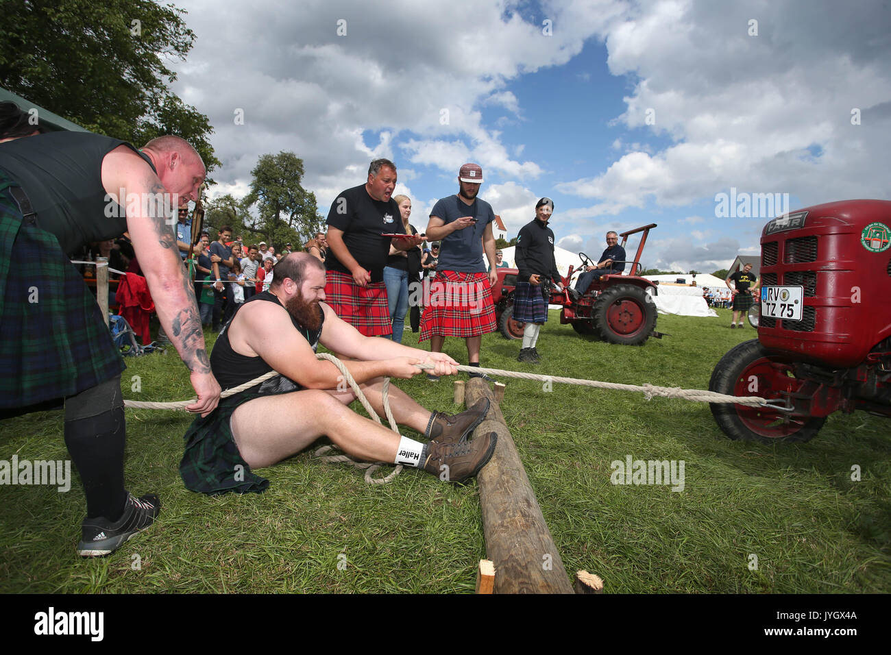 Horgenzell, Germania. 19 Ago, 2017. Un partecipante della tomaia Highlandgames sveva tira un trattore con una corda attraverso un prato nella disciplina "Bulldog-Schleppa' in Horgenzell, Germania, 19 agosto 2017. 15 clan competere gli uni contro gli altri in varie discipline al Highlandgames. Foto: Karl-Josef Hildenbrand/dpa/Alamy Live News Foto Stock