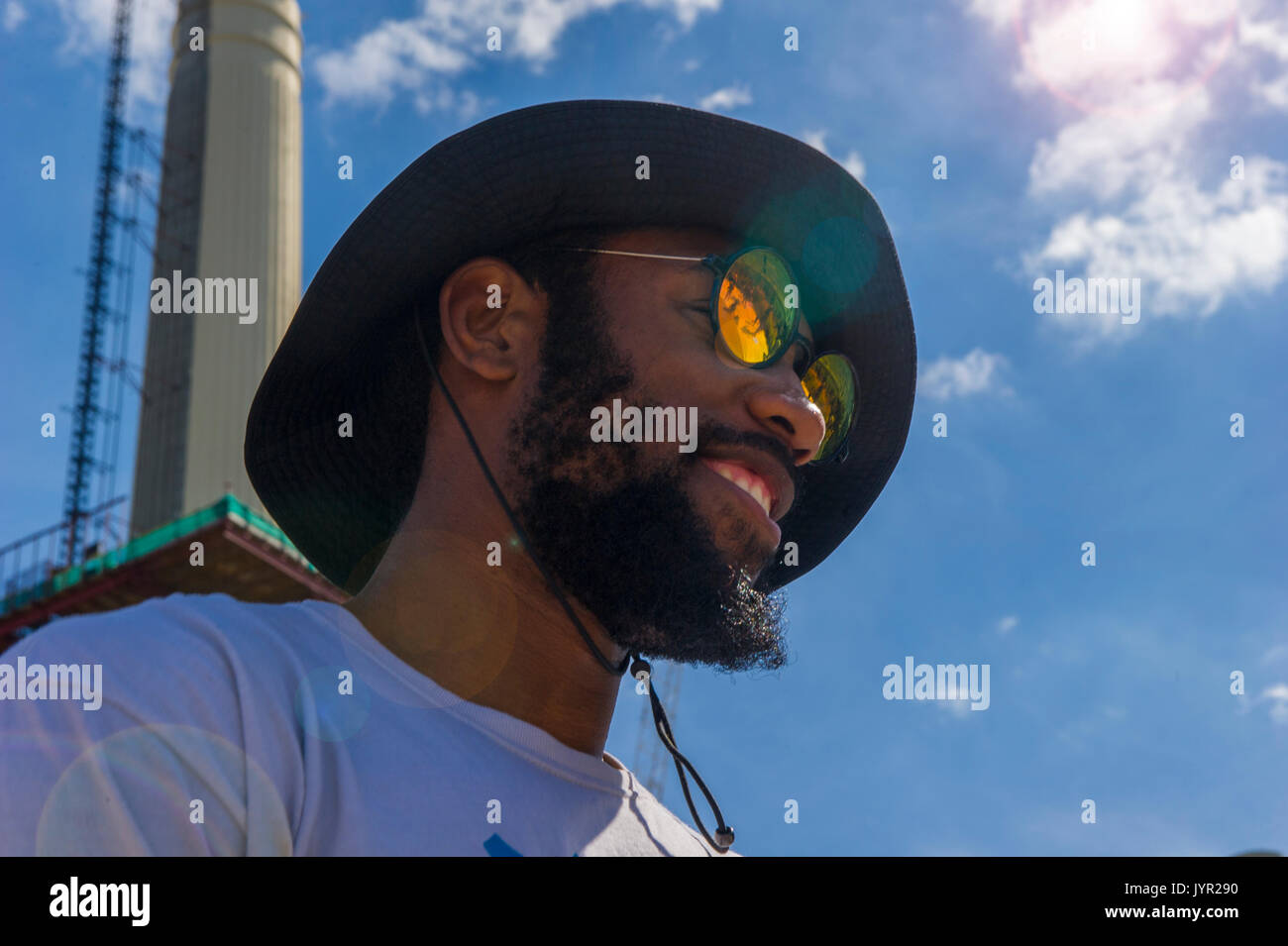 Molto cool uomo arancione con sfumature riflettente da Battersea Power Station Foto Stock