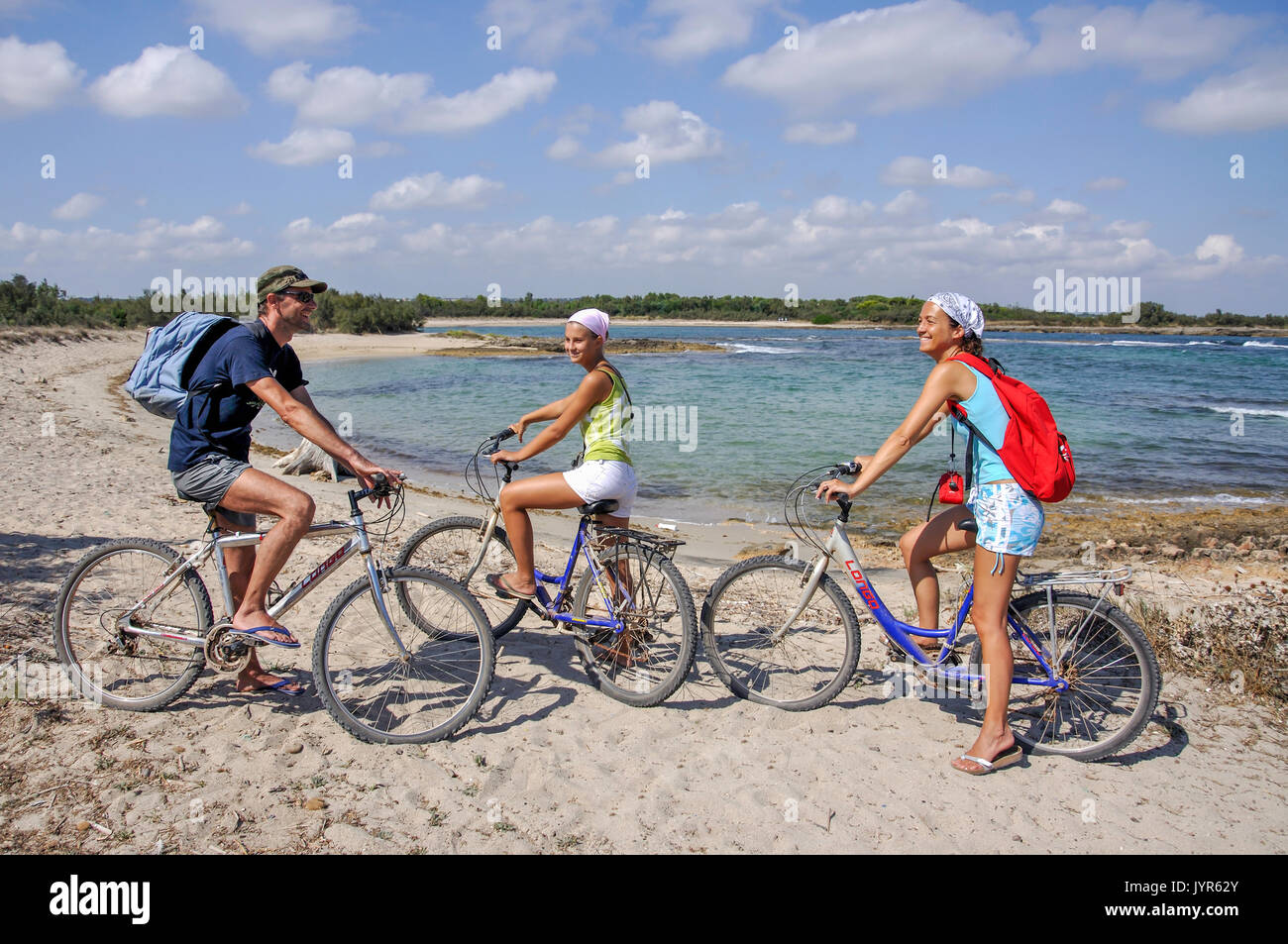 Famiglia sulle biciclette, Torre Guaceto Riserva Naturale della Provincia di Brindisi, Puglia, Italia Foto Stock