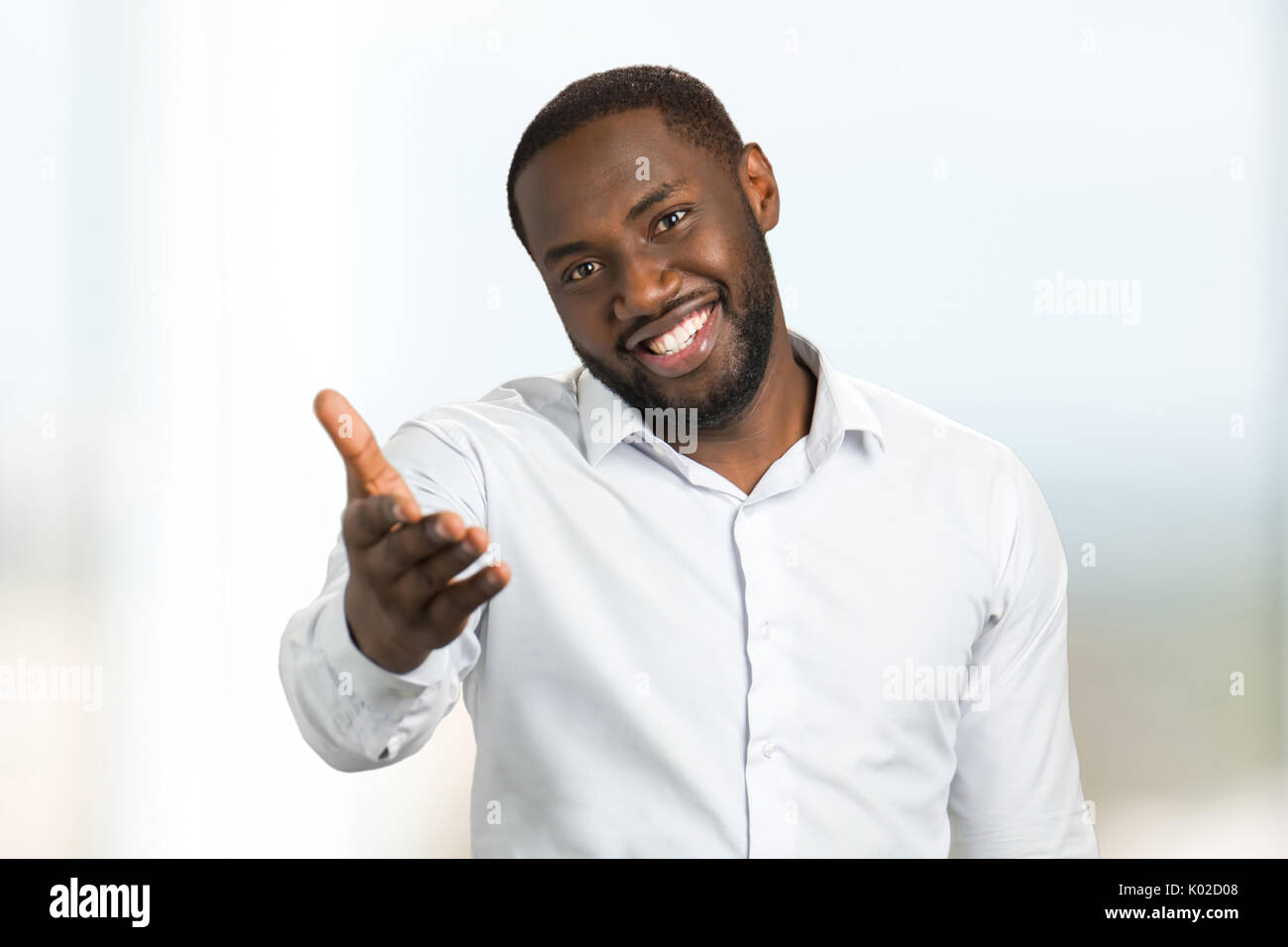 Uomo in nero shirt mano di puntamento in avanti. Gesti e le emozioni del viso di afro american Uomo in camicia bianca. Foto Stock