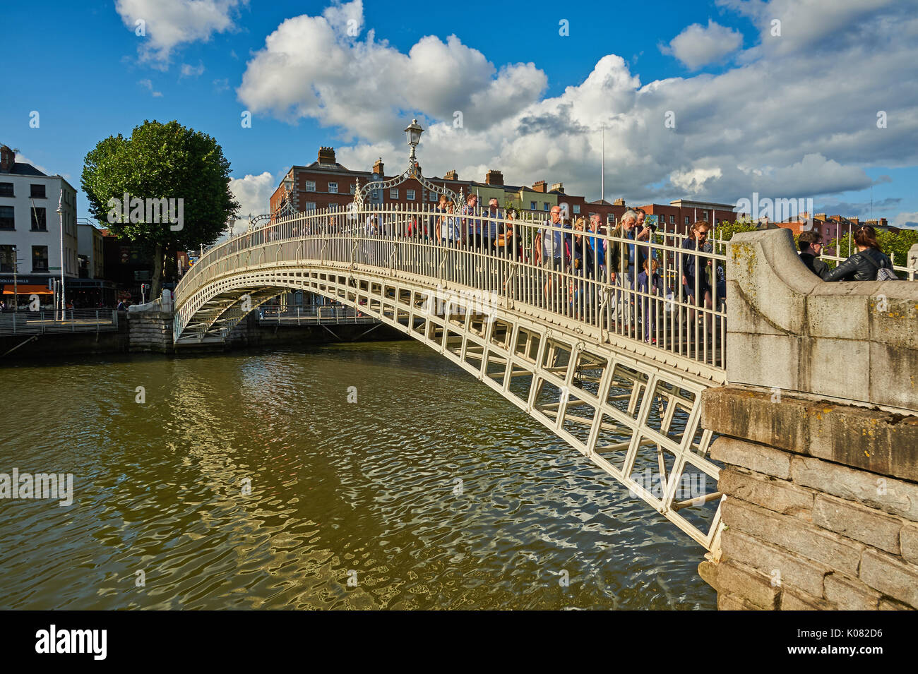 Pedoni che attraversano l'iconico Ha'penny Bridge sul fiume Liffey nel centro di Dublino, Irlanda Foto Stock