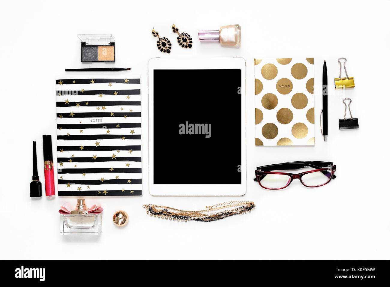 Appartamento laico femminile di moda home office area di lavoro con telefono, tazza di caffè nero elegante notebook d'oro, di cosmetici e di gioielli su sfondo bianco. vista dall'alto sulla donna lavoro di business desk Foto Stock