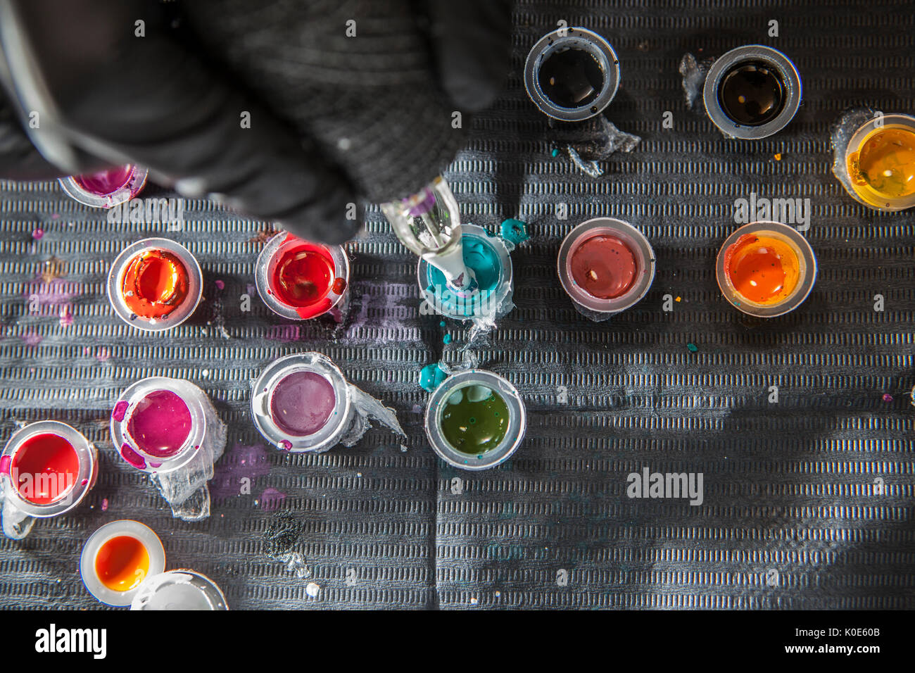 Tattoo Artist ricarica della penna con inchiostro blu. Scatto dall'alto Foto Stock