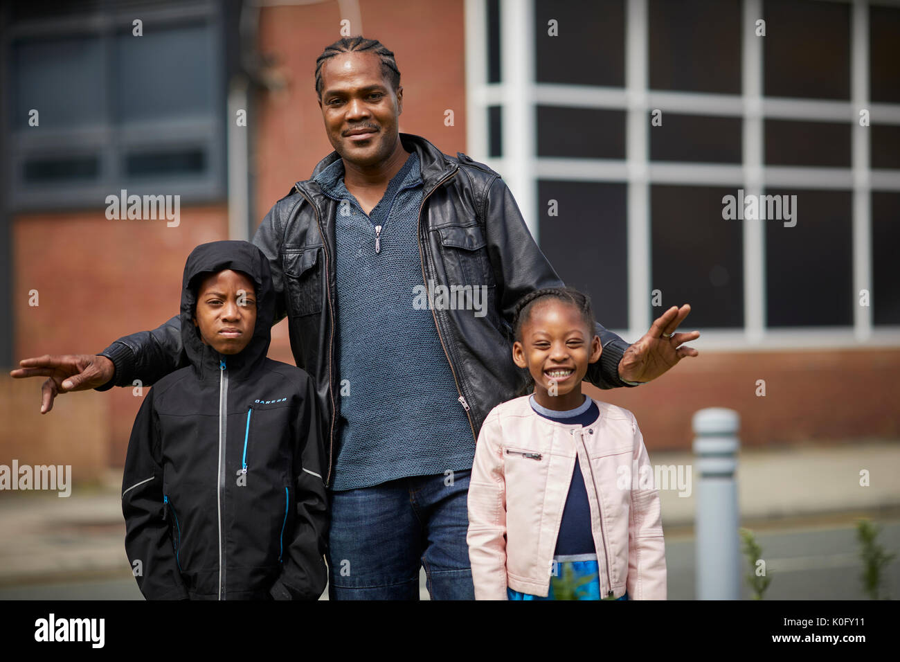 Nero locale possiede l uomo con i suoi figli in Moss Side sud sobborgo di Manchester Foto Stock