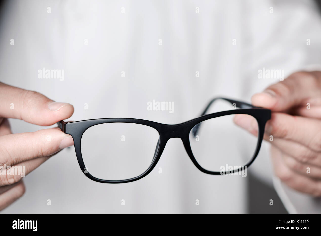 Primo piano di un giovane uomo ottico di portare un paio di occhiali per l'osservatore Foto Stock