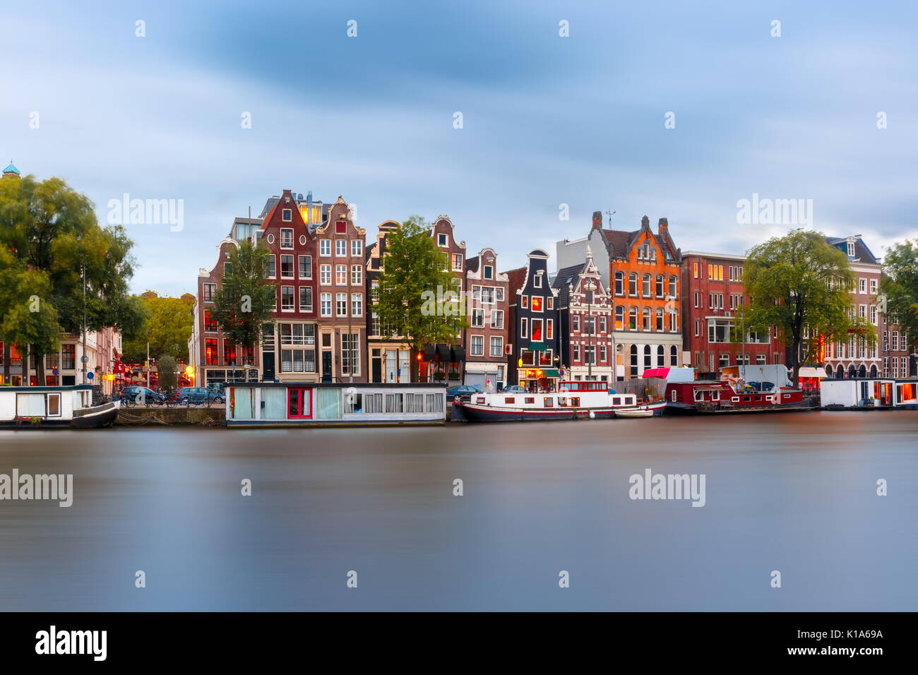 Notte Vista sulla città di Amsterdam canal con case olandesi Foto Stock