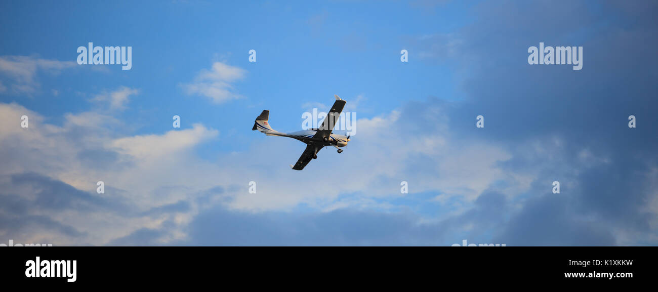 Piccolo aereo su blu cielo nuvoloso sfondo Foto Stock