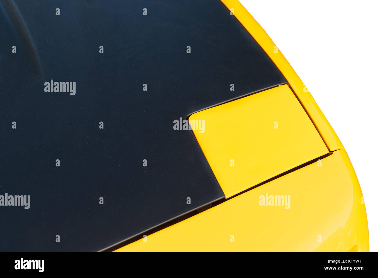 Auto sportiva il cofano di un giallo e nero colore isolata contro uno sfondo bianco. Gioco di luci e di ombre, colori e forme. Automobile astratta. Foto Stock