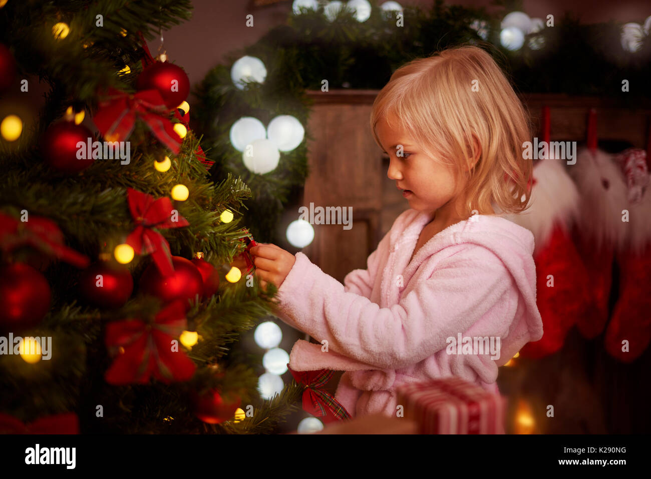 Bambina decorare un albero di natale Foto Stock