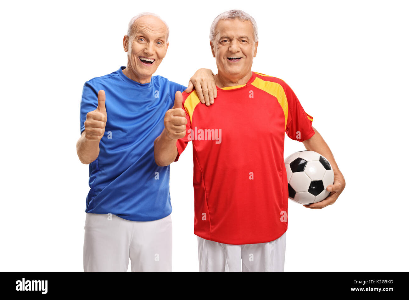Due anziani giocatori di calcio rendendo il pollice fino segni isolati su sfondo bianco Foto Stock