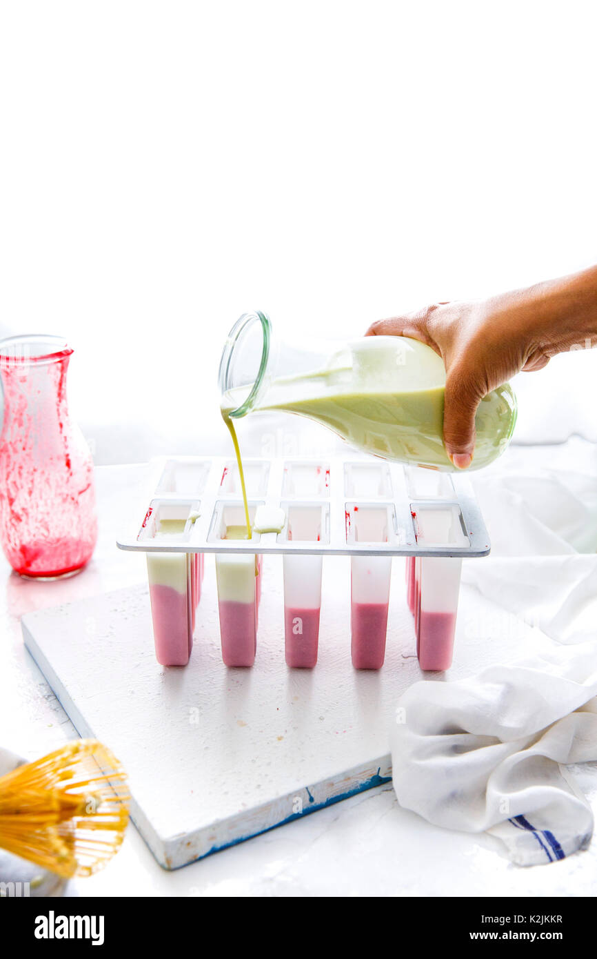 Rendendo lampone matcha popsicles cocco Foto Stock