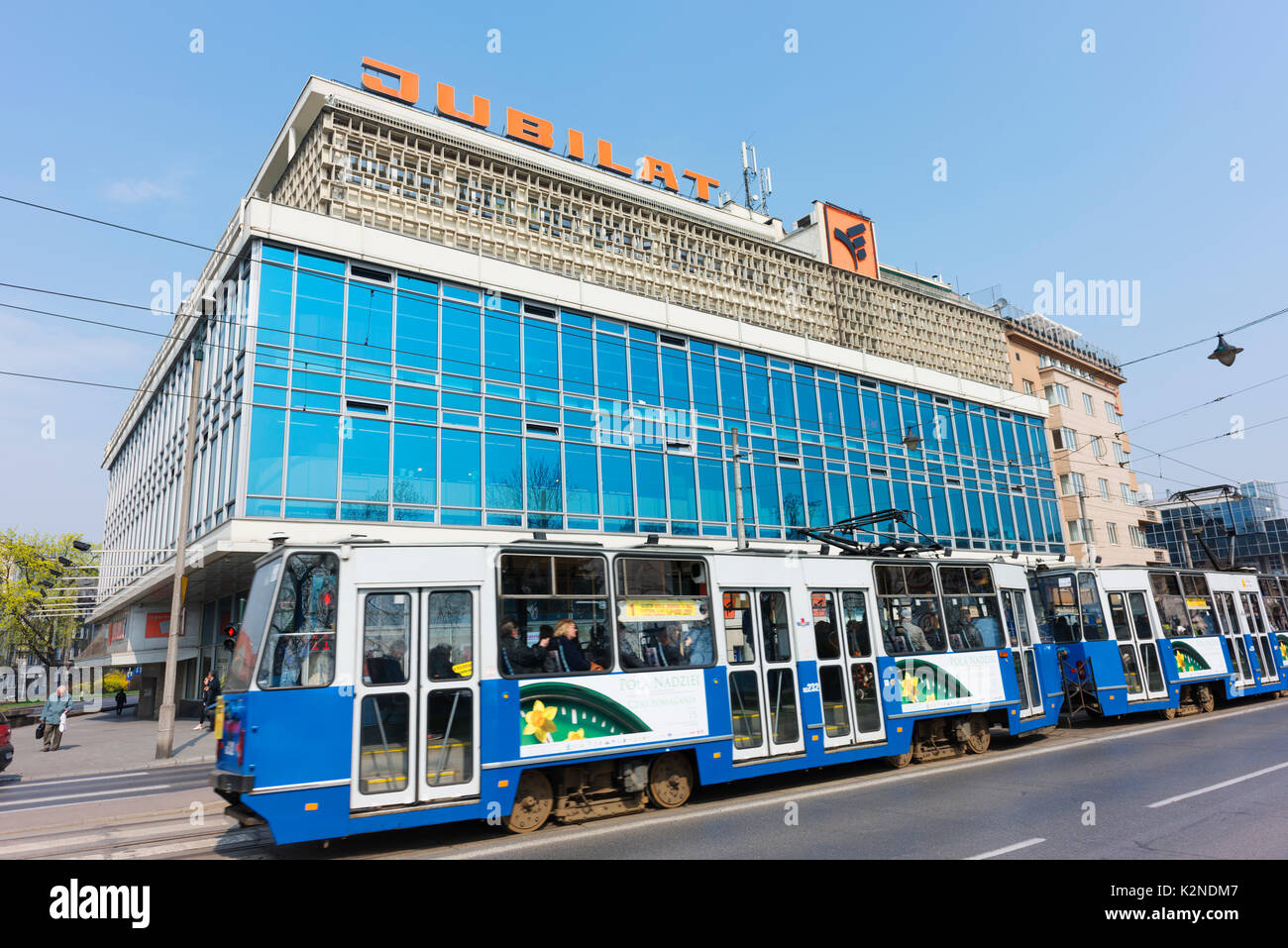 Il tram passa da jubilat, dell era sovietica department store nel centro di Cracovia. Foto Stock