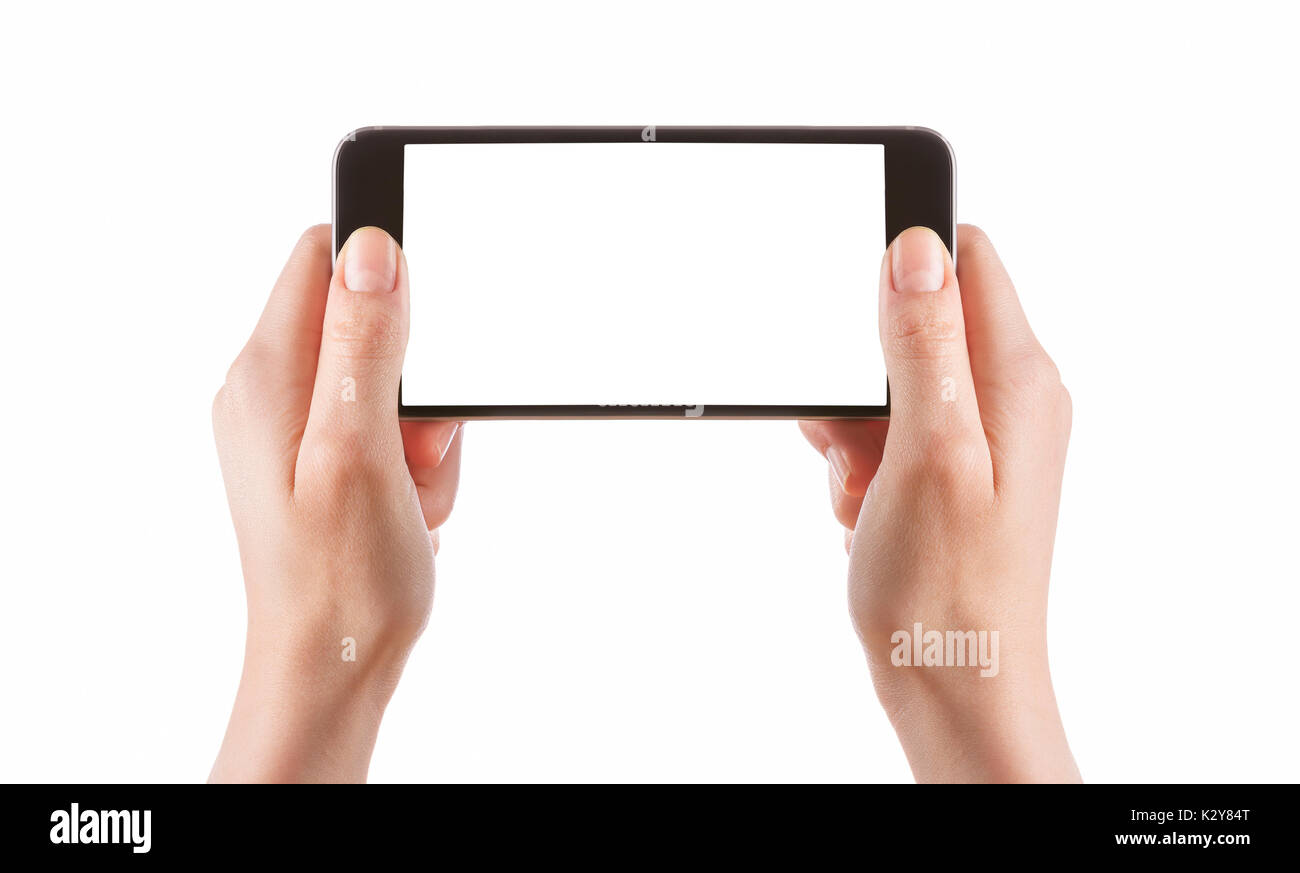 Ragazza giovane mani tenendo il nero smart phone isolato su bianco tracciato di ritaglio all'interno Foto Stock