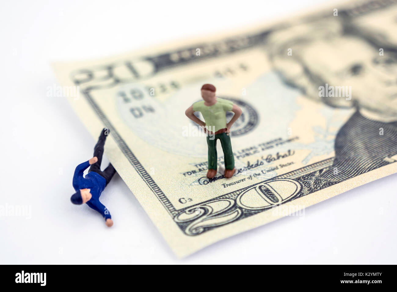 Un dollaro schiaccia un uomo in miniatura, un uomo che guarda, isolato concetto vuoto Foto Stock