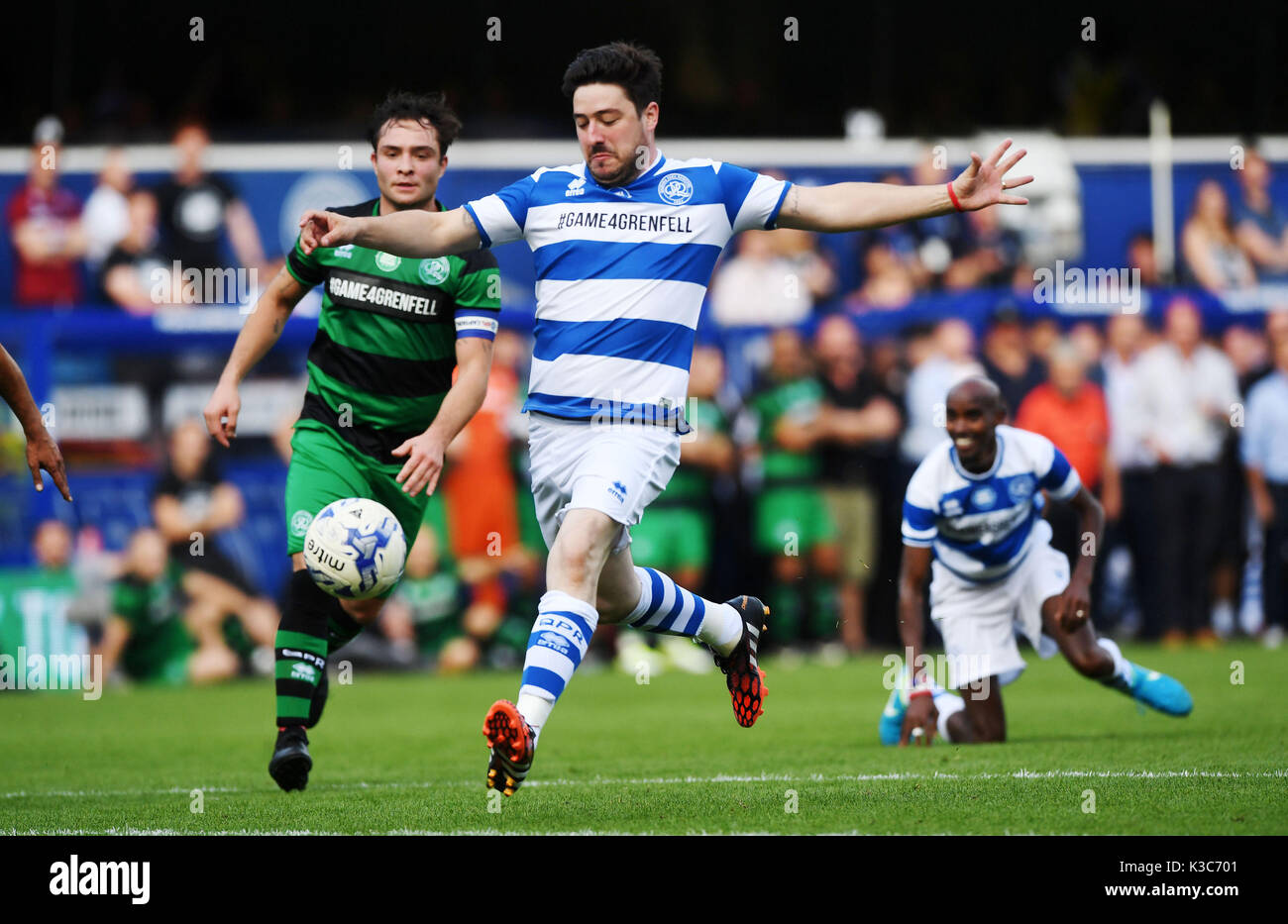 (Da sinistra a destra) Team Shearer's Ed Westwick e Team Ferdinand Sir Marcus Mumford battaglia per la sfera come Sir Mo Farah si affaccia su durante il gioco4Grenfell, una partita di calcio di beneficenza per raccogliere fondi per Grenfell Torre superstiti, a QPR's Loftus Road Stadium di Londra. Foto Stock