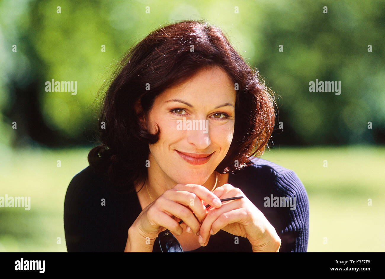 Ritratto di sorridere, scuro dai capelli donna Foto Stock
