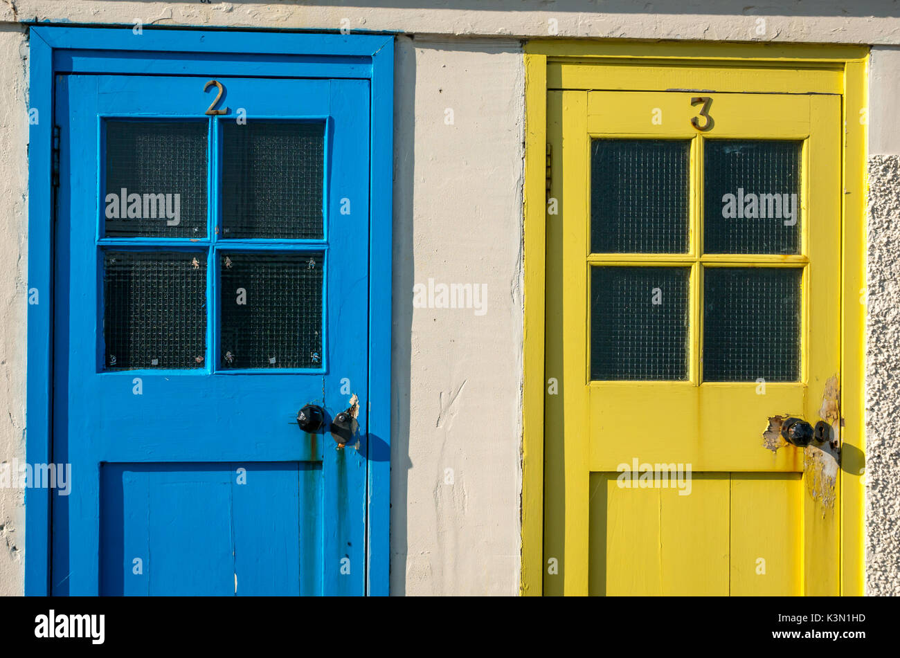 Close up di colorati di blu e giallo vecchie porte a North Berwick Harbour, East Lothian, Scozia, precedentemente piscina spogliatoi Foto Stock