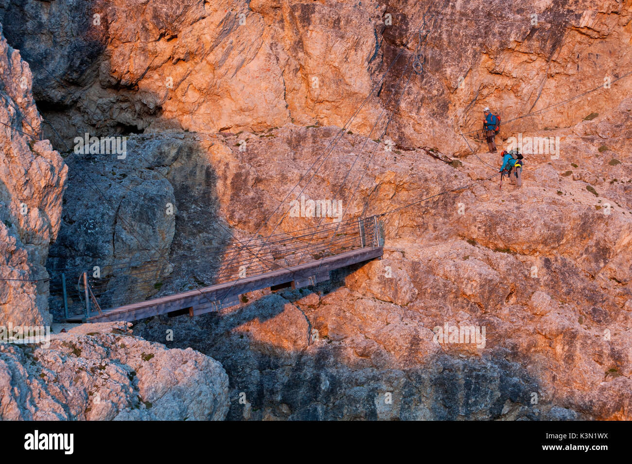 L'Europa, Italia, Veneto, Belluno. Due escursionisti in prossimità del ponte sospeso con cavi di acciaio lungo il sentiero Kaiserjaeger, Lagazuoi, Dolomiti Foto Stock