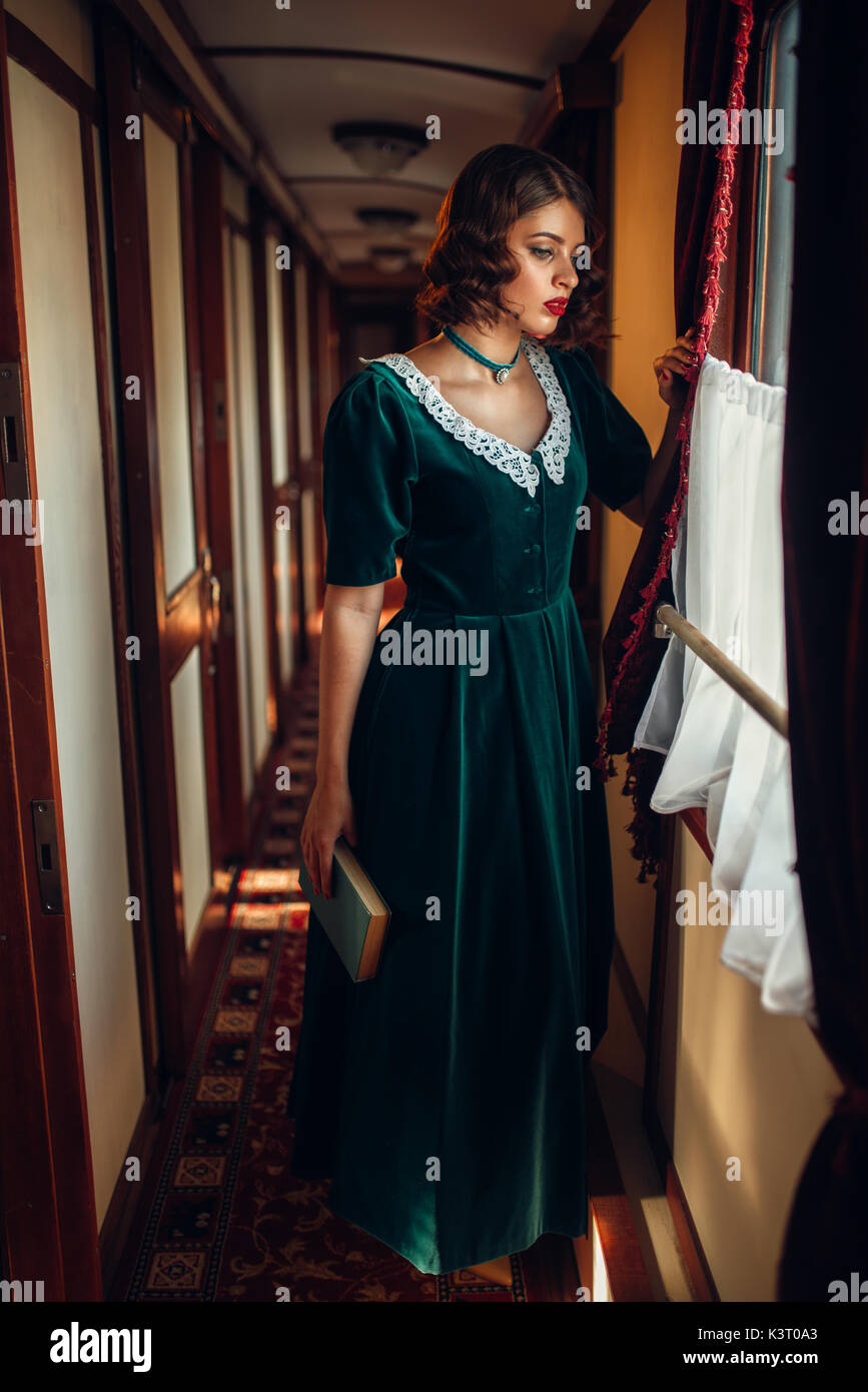 Giovane donna viaggi, treno vintage vano. Il vecchio carro interni. Viaggio ferroviario, viaggio ferroviario Foto Stock
