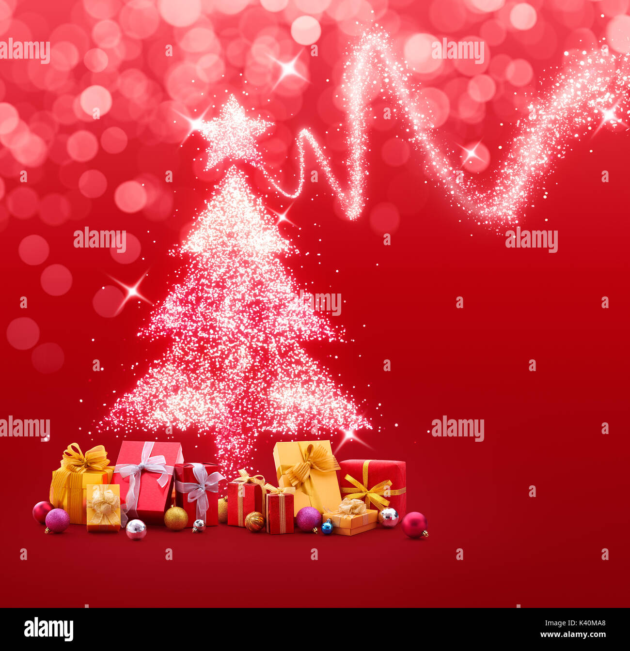 Albero di Natale fatto di bagliori e luci con doni e baubles su sfondo rosso Foto Stock