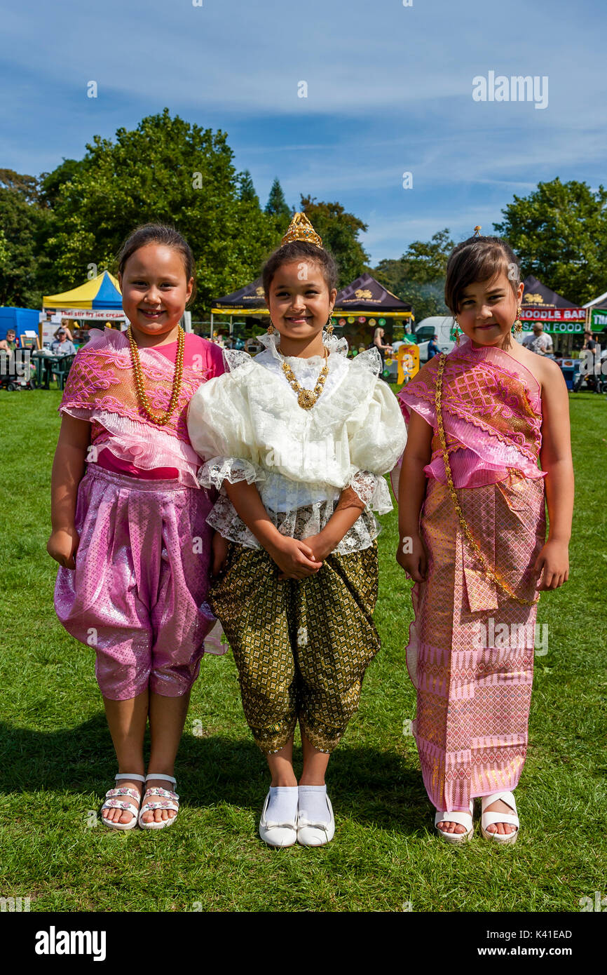 Tre bambini Anglo-Thai vestite nel tradizionale costume tailandese, Brighton festival Tailandese, Brighton, Sussex, Regno Unito Foto Stock