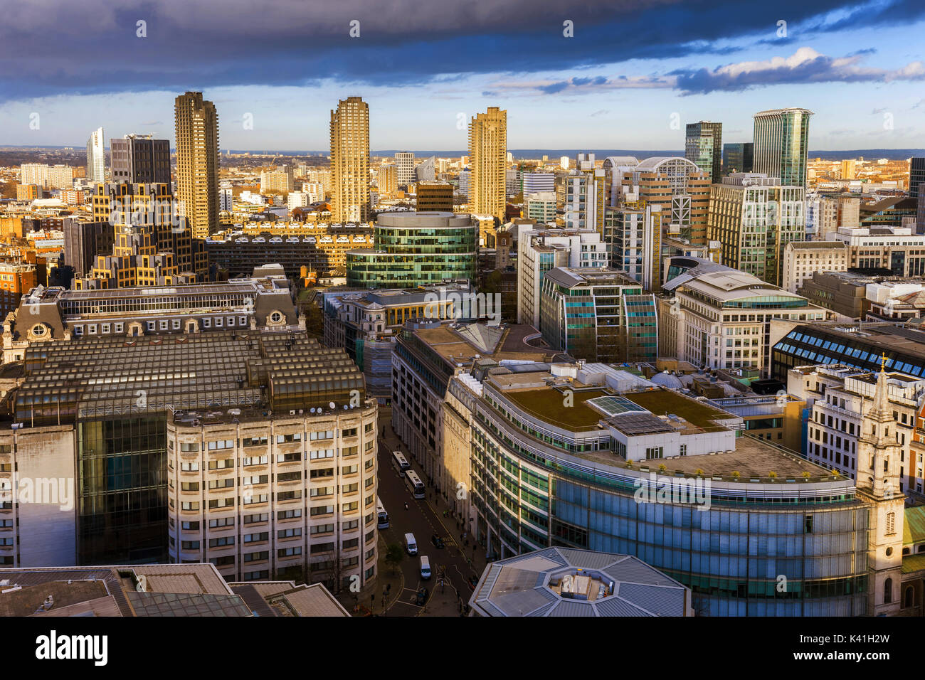 Londra, Inghilterra - Antenna vista sullo skyline della banca quartiere di Londra e il Barbican a gloden ora con cielo blu e nuvole Foto Stock
