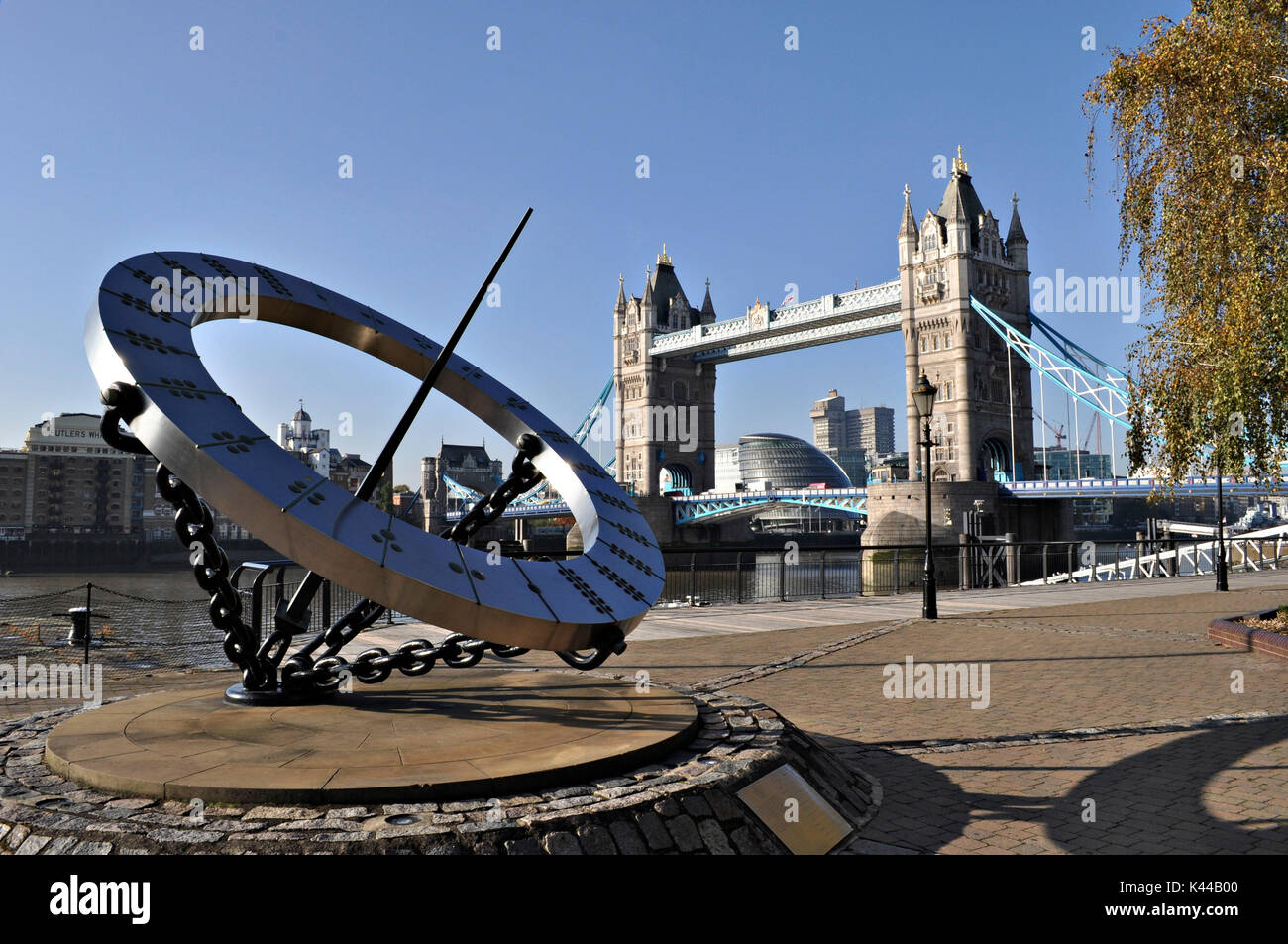 Il Tower Bridge e la vigilanza scultura raffigurante una meridiana, Wendy Taylor. Simbolo della città di Londra, questo monumento non delude mai, con il suo stile neo-gotico di torri e di supporto cavi di colore blu è un vero spettacolo. Foto Stock