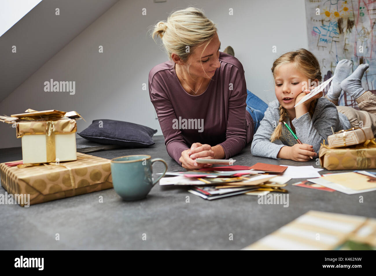 Madre e figlia scrivere cartoline di Natale Foto Stock