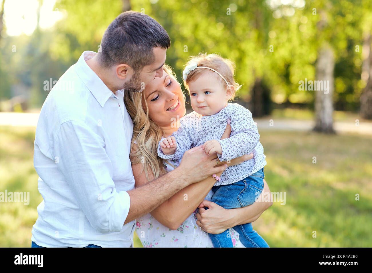 La famiglia felice in un parco in estate autunno. Foto Stock