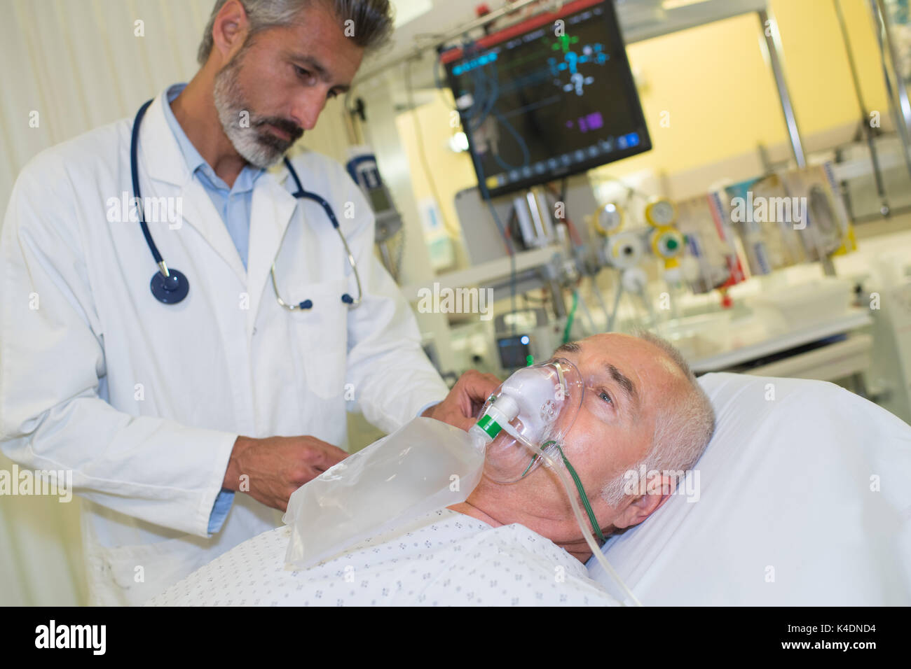Medico con il paziente che indossa la maschera di ossigeno Foto Stock
