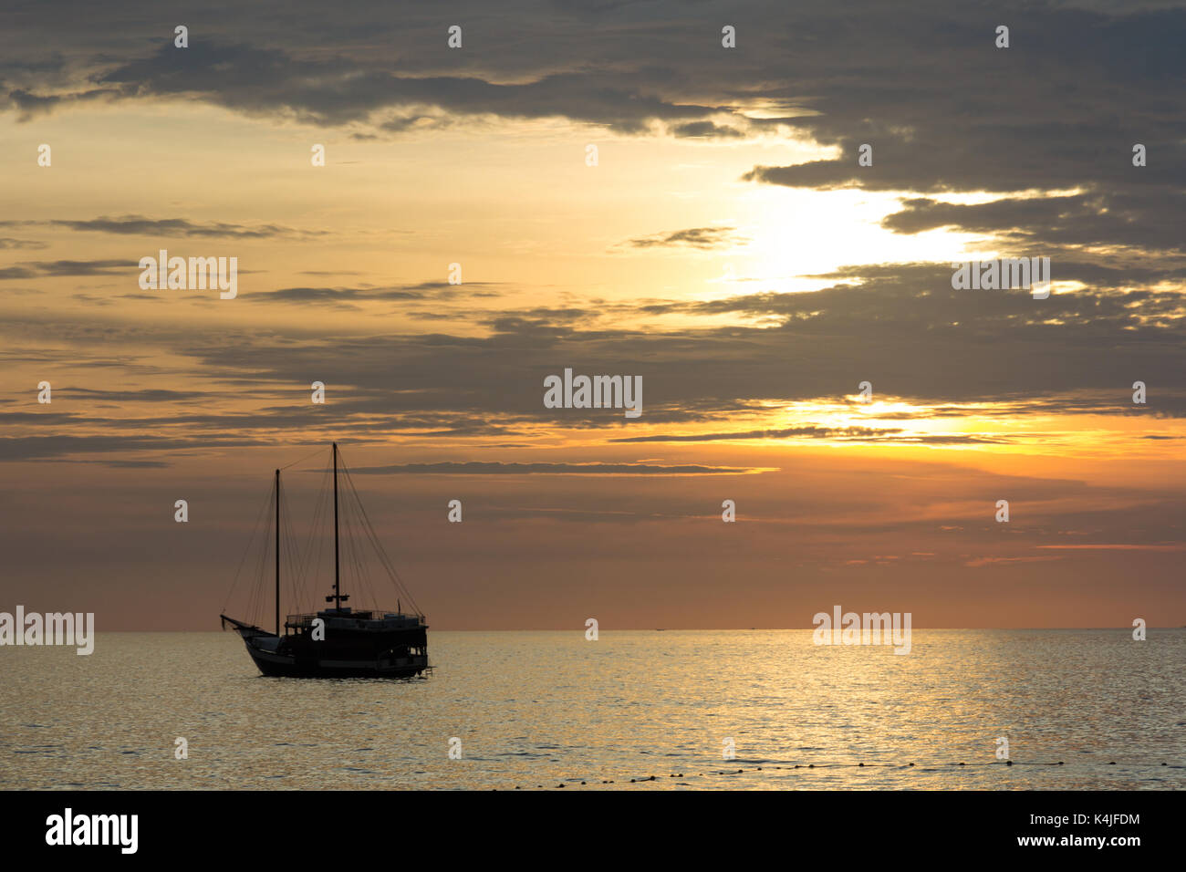 Silhouette in barca al tramonto, Surin Beach, Phuket, Tailandia Foto Stock