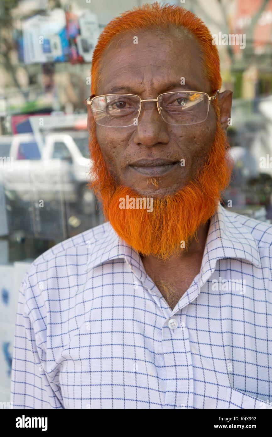 Un uomo del Bangladesh con henna morì orange capelli e barba sulla 74a Strada di Jackson Heights, Queens, a New York City Foto Stock