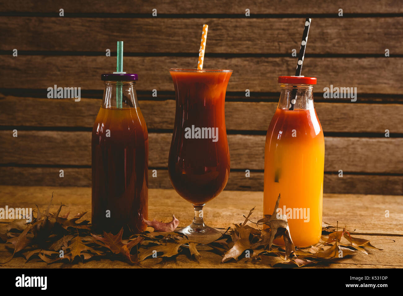 Le bevande con foglie di autunno sul tavolo di legno Foto Stock