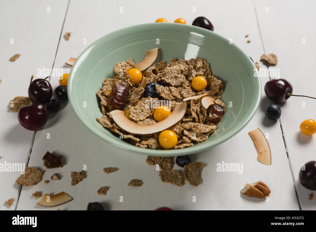 Ciotola di fiocchi di frumento con mirtillo e golden berry su tavola Foto Stock