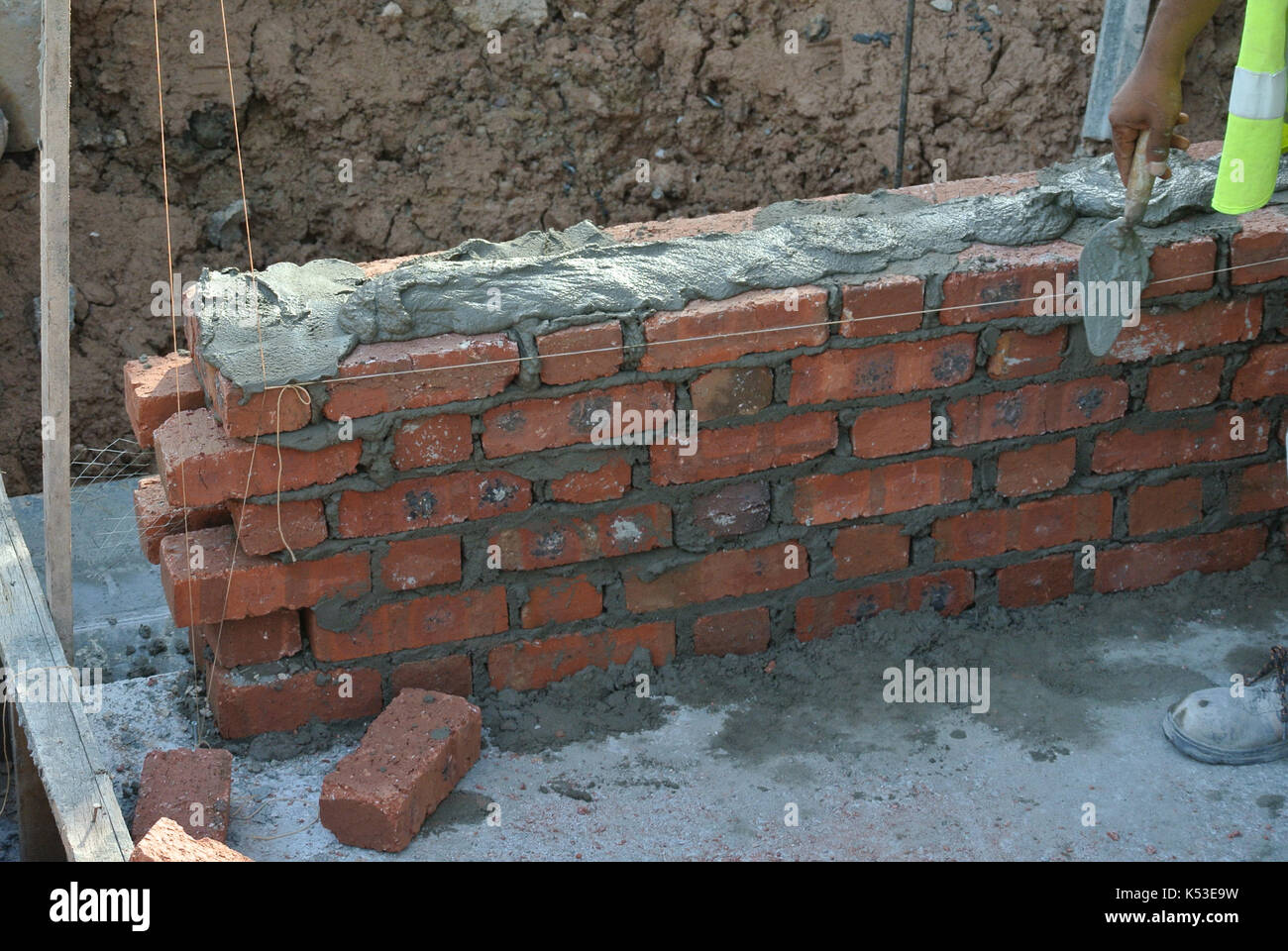 Selangor, Malaysia - gennaio 15, 2017: muratore laici mattoni di argilla blocco e impilata insieme con malta di cemento per formare pareti in corrispondenza della costruzione Foto Stock