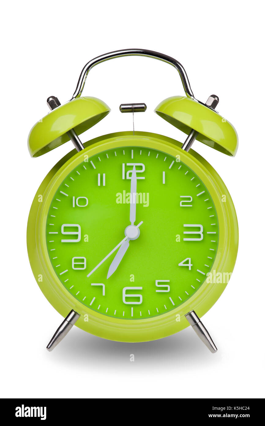 Green orologio sveglia con le mani alle 7 am o pm isolato su uno sfondo bianco. uno di una serie di 12 immagini che mostra la parte superiore di ogni ora a partire da 1 a Foto Stock