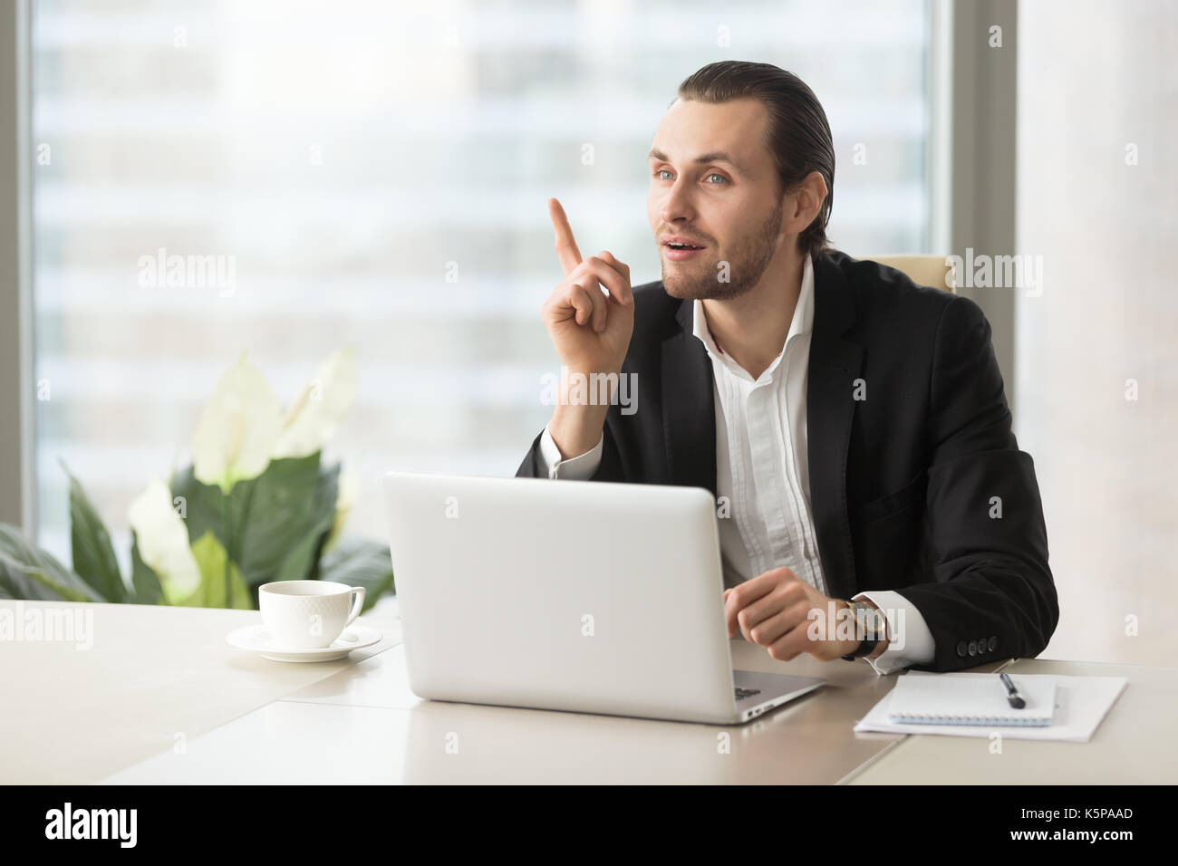 Giovane imprenditore è diventato improvvisamente grande idea alla scrivania. Foto Stock