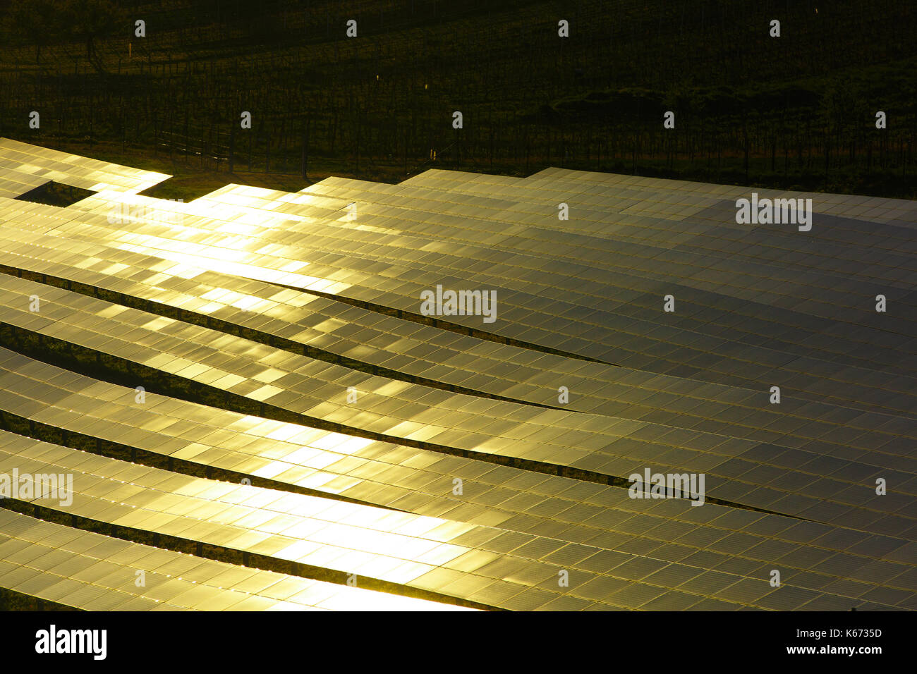 Pannelli solari fotovoltaici nella luce del sole incandescente. produzione sostenibile di energia elettrica e la distribuzione, con texture di sfondo e copiare lo spazio. Foto Stock