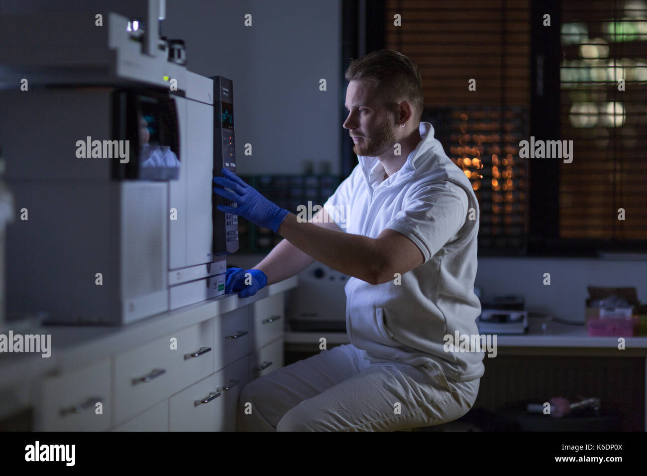 Maschio senior researcher di effettuare attività di ricerca scientifica in un laboratorio (shallow dof; dai toni di colore immagine) Foto Stock