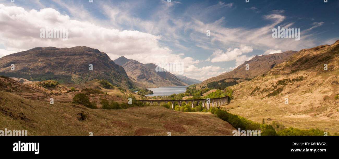 Il viadotto Glenfinnan porta la West Highland linea ferroviaria alta sopra glen finnan vallata oltre i laghi e le montagne della Scozia. Foto Stock