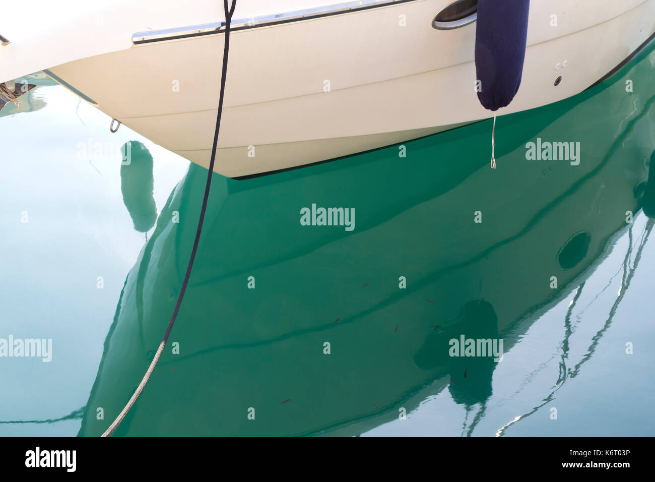 Ormeggiate le piccole imbarcazioni galleggiante su un verde mediterraneo mare piatto Foto Stock