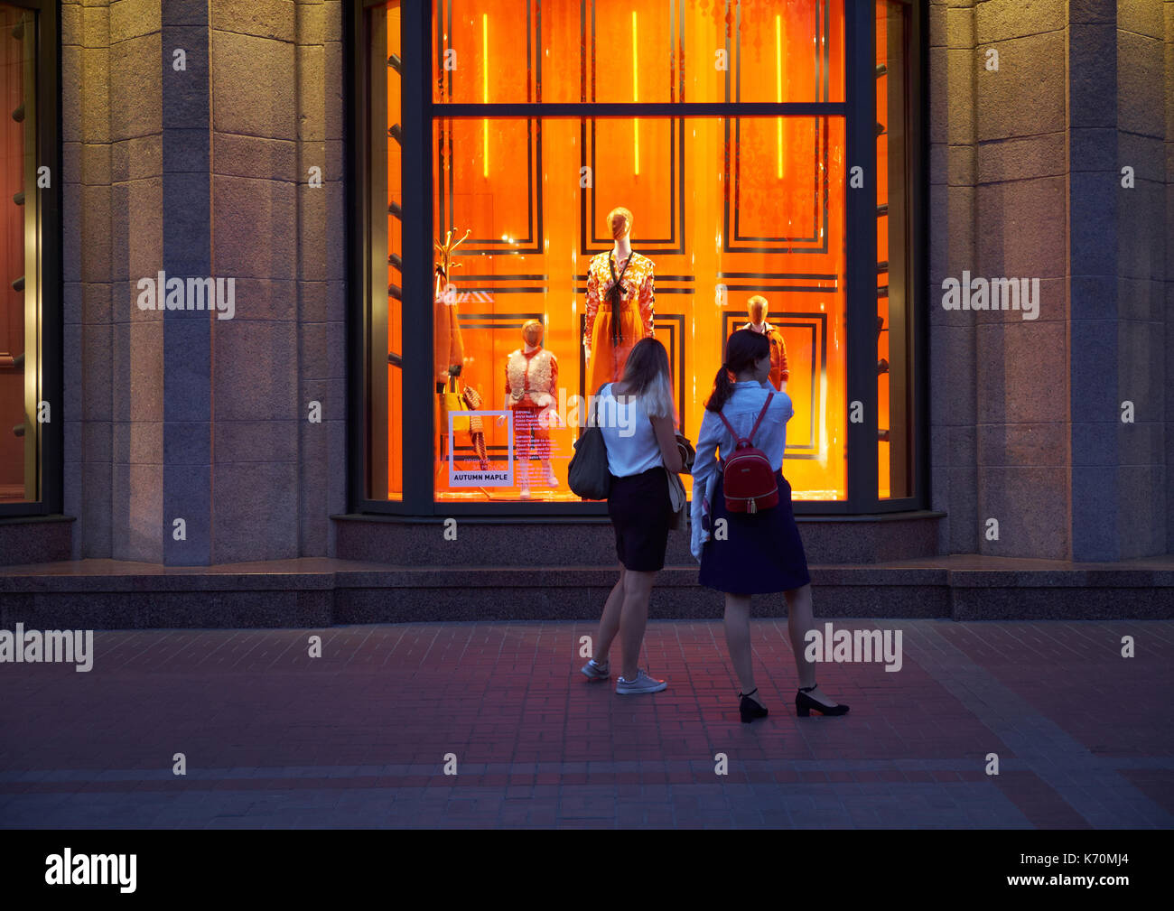 Kiev, Ucraina - 04 settembre 2017: due giovani donne indossava magliette bianco e scuro gonne in piedi sul marciapiede di fronte al central department store (TSU Foto Stock