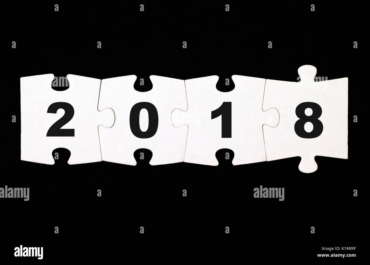 Quattro pezzi di un puzzle con i numeri 2 0 1 8 sono collegati insieme su sfondo nero Foto Stock