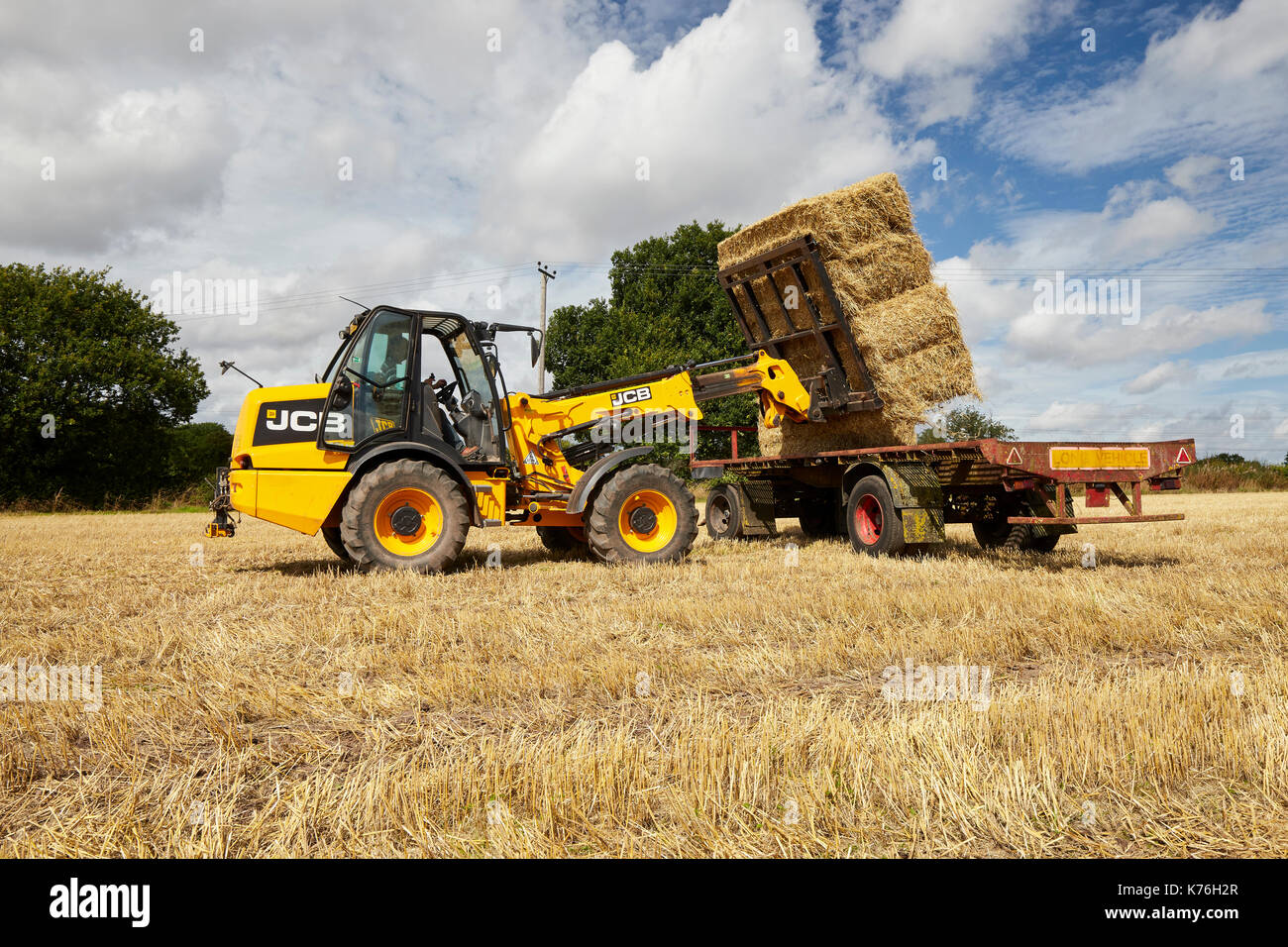 Impilatura di balle di paglia con un JCB TM 130s durante il raccolto REGNO UNITO Foto Stock