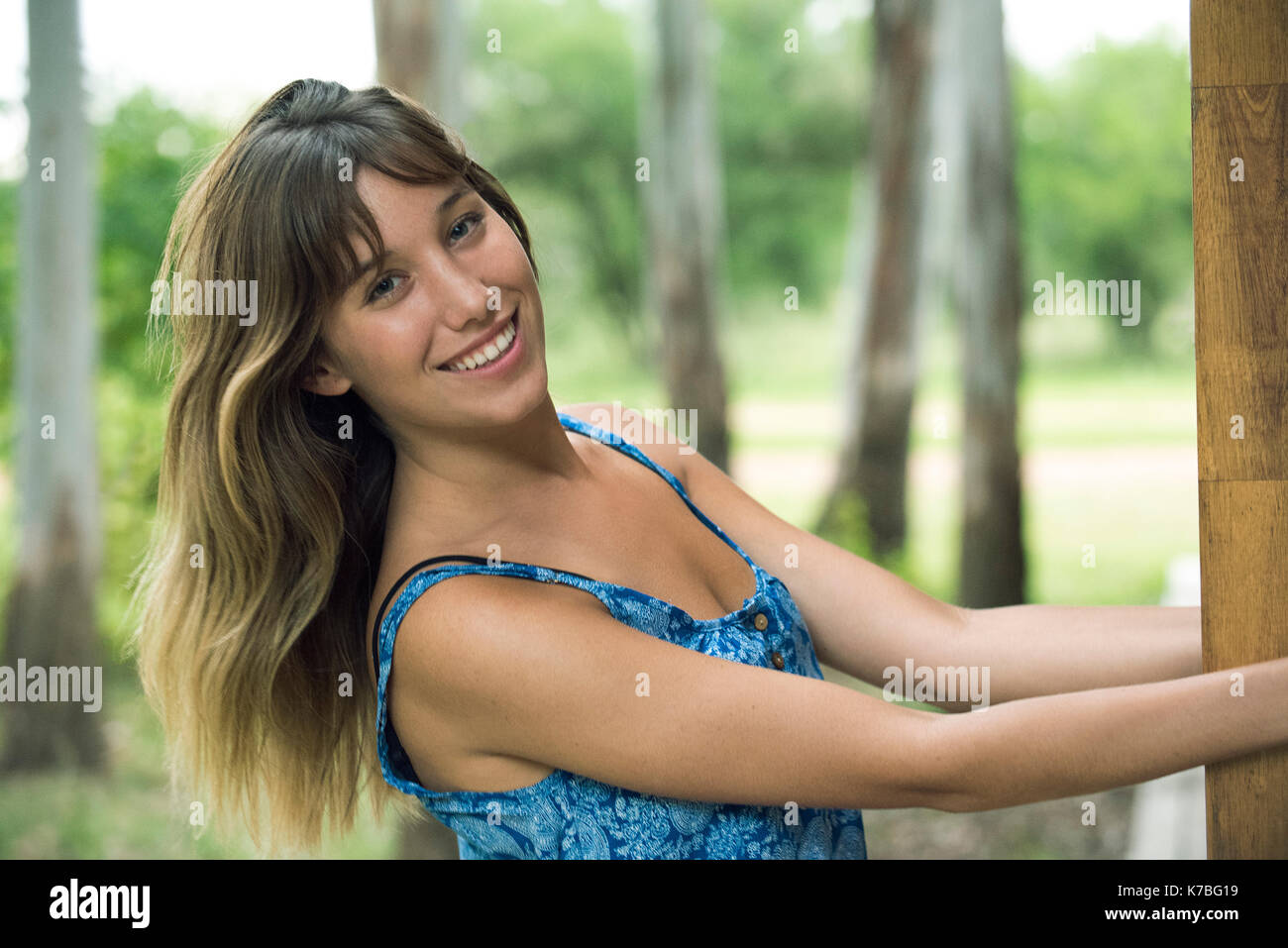 Giovane donna sorridente allegramente all'aperto, ritratto Foto Stock