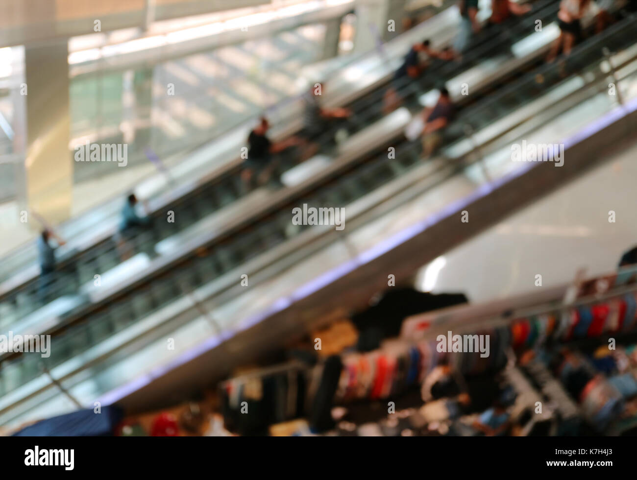 Abstract sfocati molte persone sulle scale mobili in un centro commerciale per lo shopping, sfondo Foto Stock