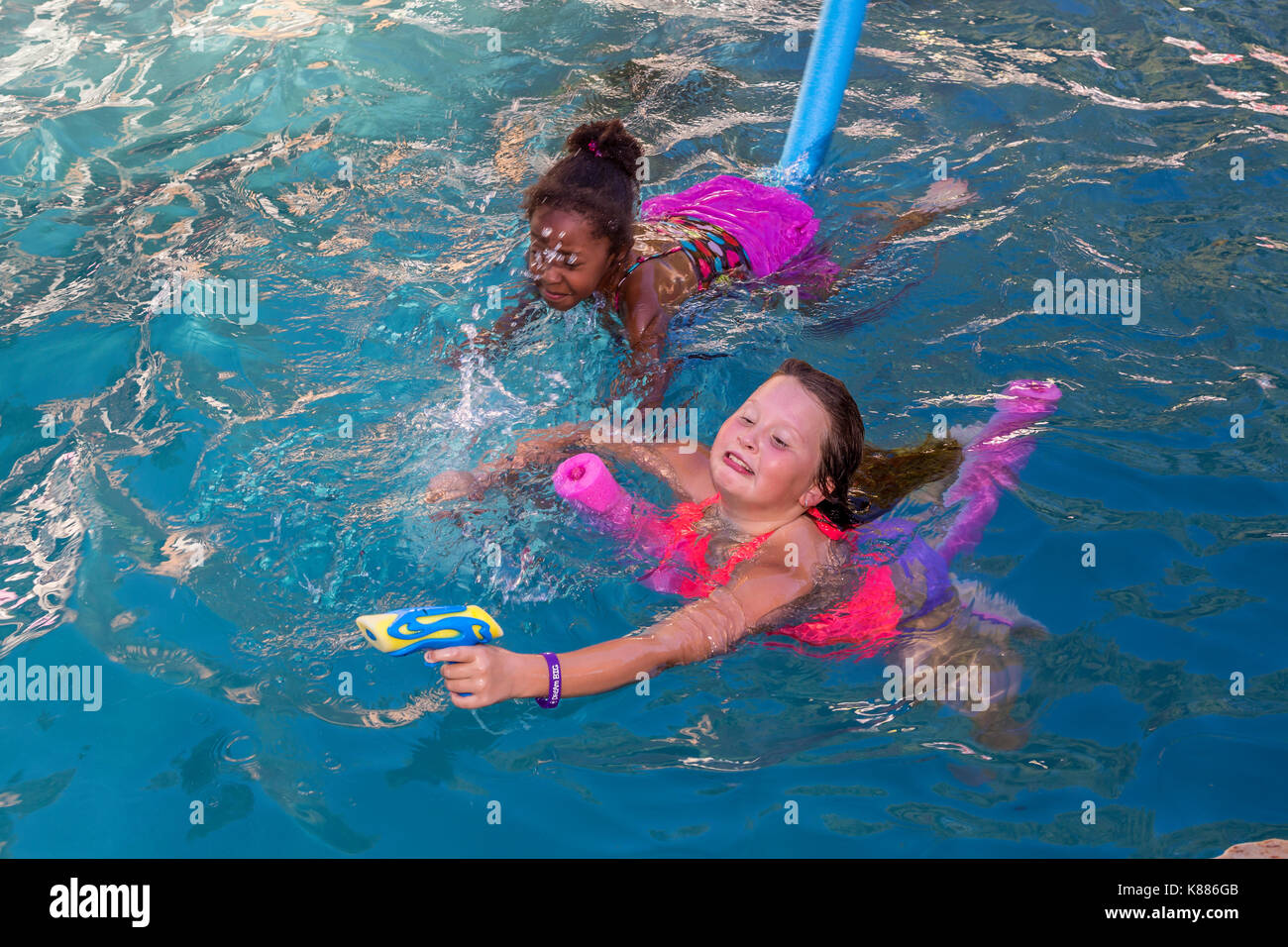 Le bambine e i bambini, giocando, schizzare acqua soaker, piscina, piscina di acqua dolce, party in piscina, Castro Valley, contea di Alameda, California, unità Foto Stock