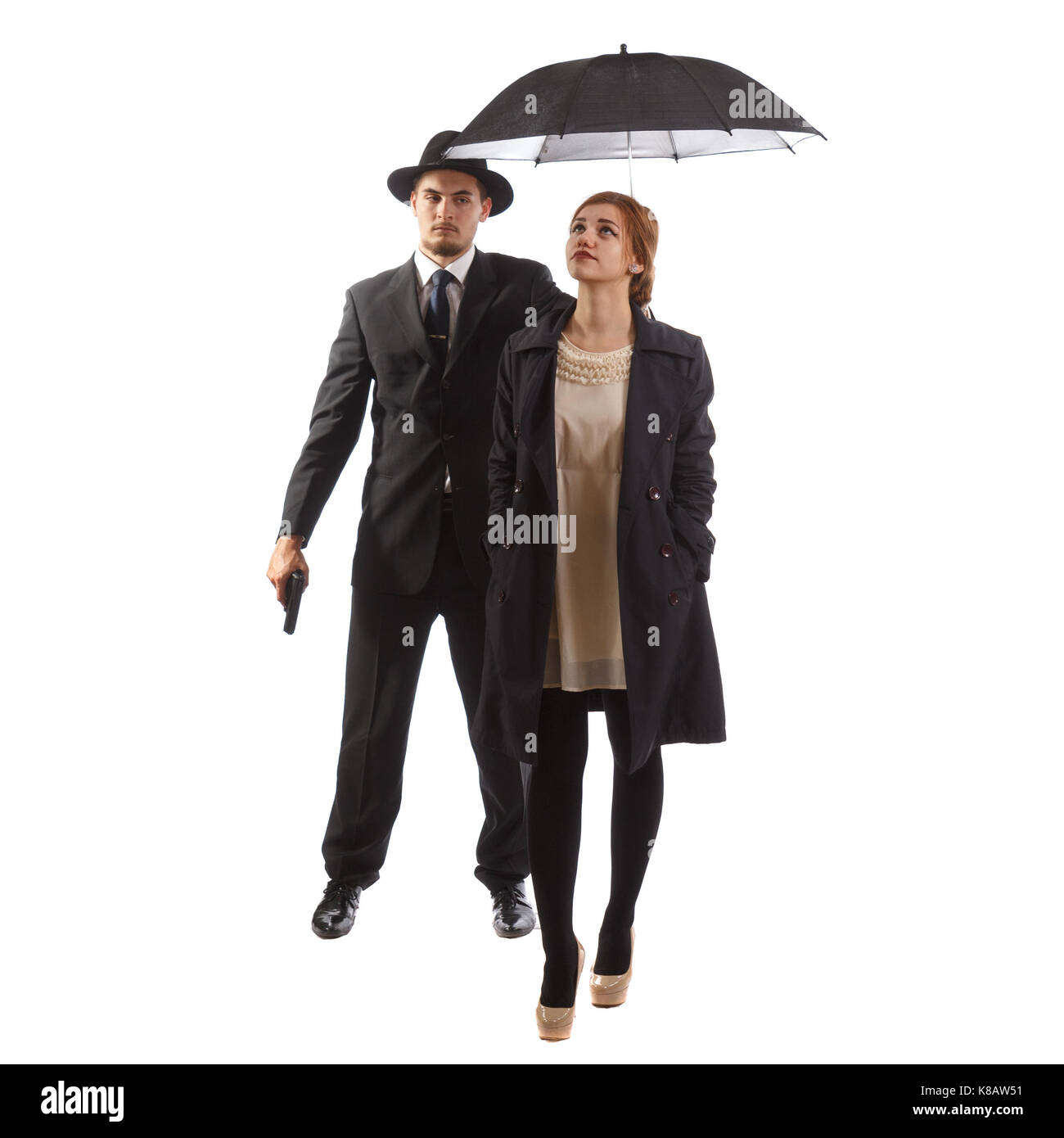 Una signora in abbigliamento formale con la sua guardia del corpo tenendo un ombrello Foto Stock